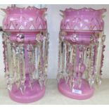 A pair of pink overlaid glass lustres with cut glass drops (1 a.f.)