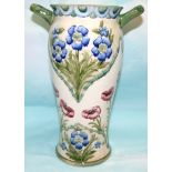 A William Moorcroft Florian vase of 2 handled baluster form, decorated with red poppies and blue