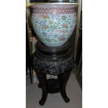 A mid-20th century Chinese fish bowl with orange coloured design, on floor standing hardwood base