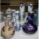 Two pairs of modern Delft vases; a 1930's blue lustre vase; a stoneware vase decorated with fighting