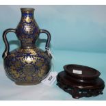 A Chinese 2 handled vase, double gourd shaped, with extensive gilt decoration on powder blue ground,