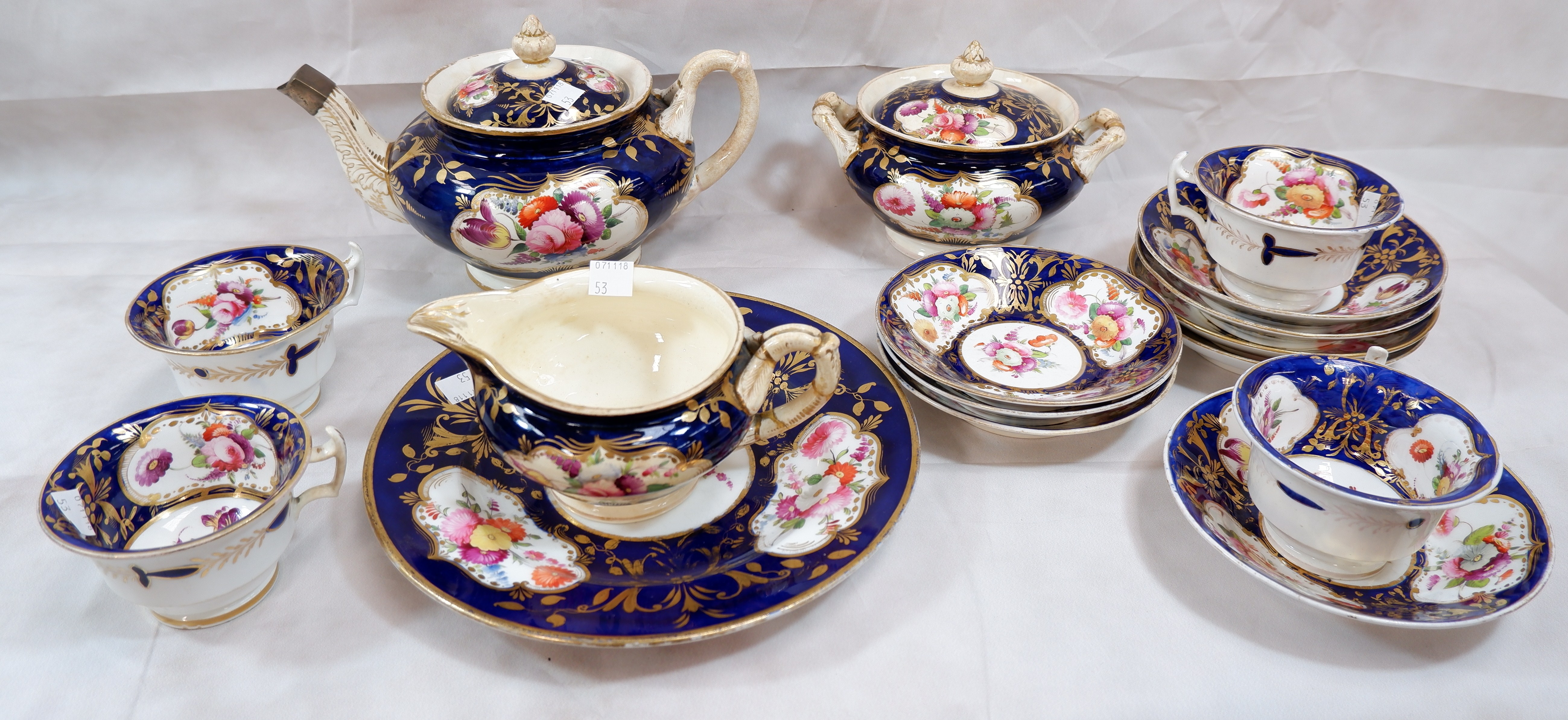 A 19th century English bone china tea service with hand enamelled floral decoration in gilt