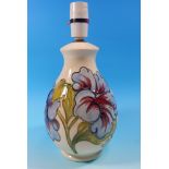A Moorcroft baluster table lamp decorated with hibiscus against a cream ground, impressed