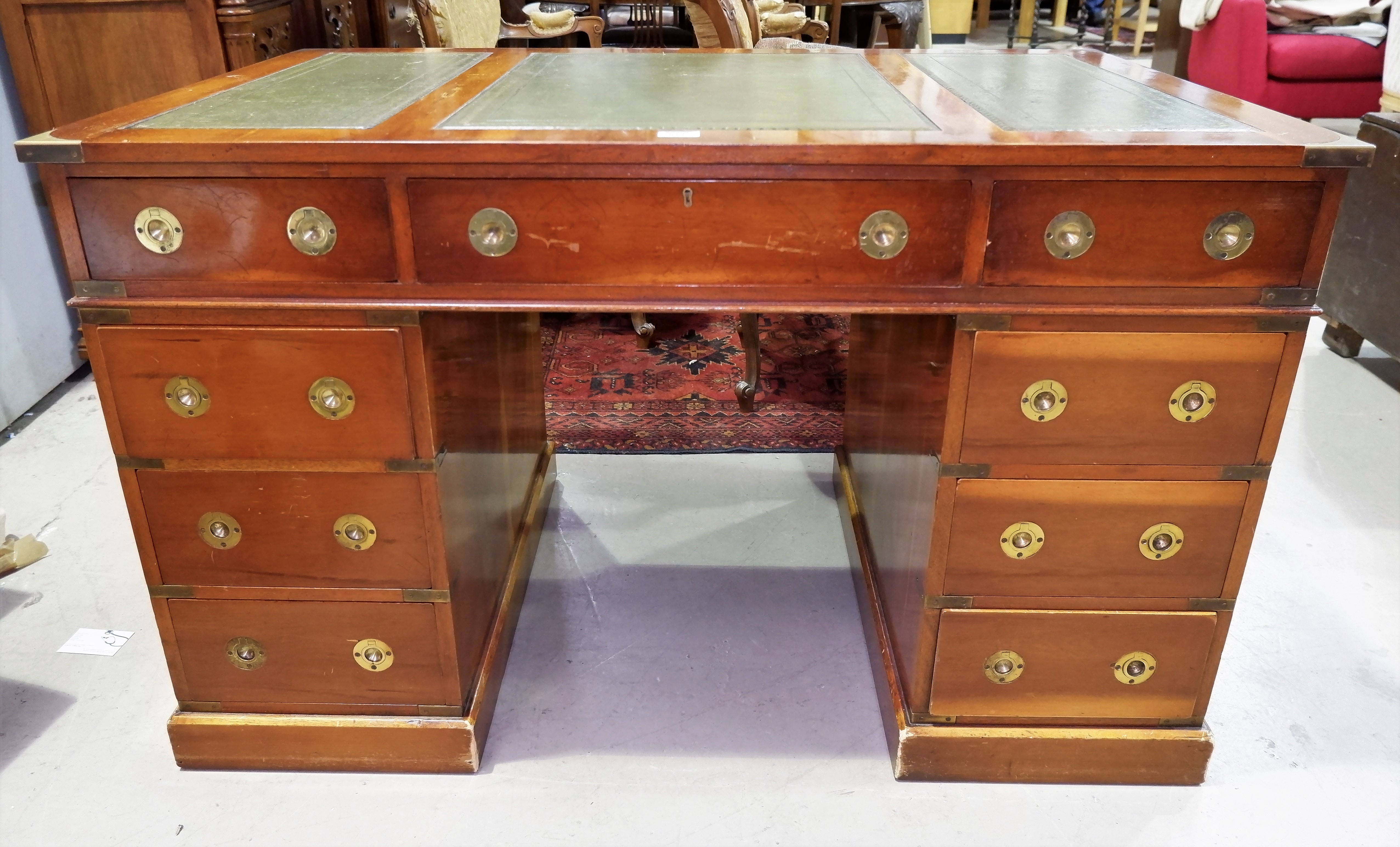 A military style yew wood kneehole desk twin pedestals, 3 frieze and 6 pedestal drawers with inset