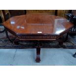 An inlaid mahogany reproduction coffee table, with octagonal top, column supports and splay feet