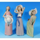 Three Lladro figures of girls posing, with white bonnets, 9-11"