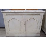 A French style kitchen cupboard, white painted wood, with double doors and pullout slide