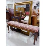 A large gilt framed mirror; another; a long stool