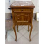 A 19th century French bedside cabinet in walnut with marble top, on cabriole legs