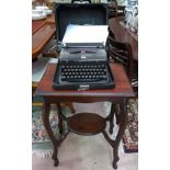 A mahogany occasional table with shelf below and a cased Royal typewriter