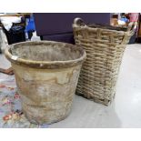 An animal hide circular basket; a woven wood basket