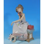 A Lladro figure of a girl talking on the telephone, 8"