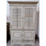 A continental limed wood combination wardrobe with double cupboard above, hanging space and shelves,