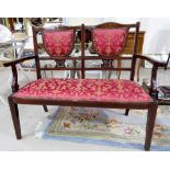 An Edwardian inlaid mahogany 2 seater settee upholstered in red/gilt dralon