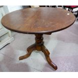 A Victorian pine occasional table with circular tilt top; a brass occasional table on folding