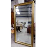 A large bevelled edge wall mirror with geometric decoration, in gilt classical style frame, 72" x