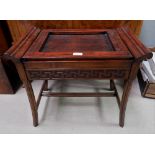 An oriental hardwood stool with geometric decoration, on carved legs