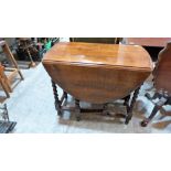 A 1920's oak gateleg table on barleytwist supports. 35'' wide