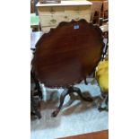 A mahogany tripod table, the round piecrust moulded snap top on a ring turned column and acanthus