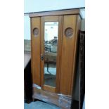 An Edward VII satinwood wardrobe enclosed by a mirror door over a base drawer. 34''