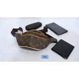 A Louis Vuitton Parfums type gift set with bag, a Giovanni Armani hard shell sunglasses case and two