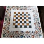 An Indian marble and pietra-dura chessboard. 25'' x 25''