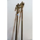 A pair of high church brass processional maces surmounted by a crucifix and bells. 85'' high