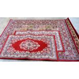 Four Belgian red ground rugs