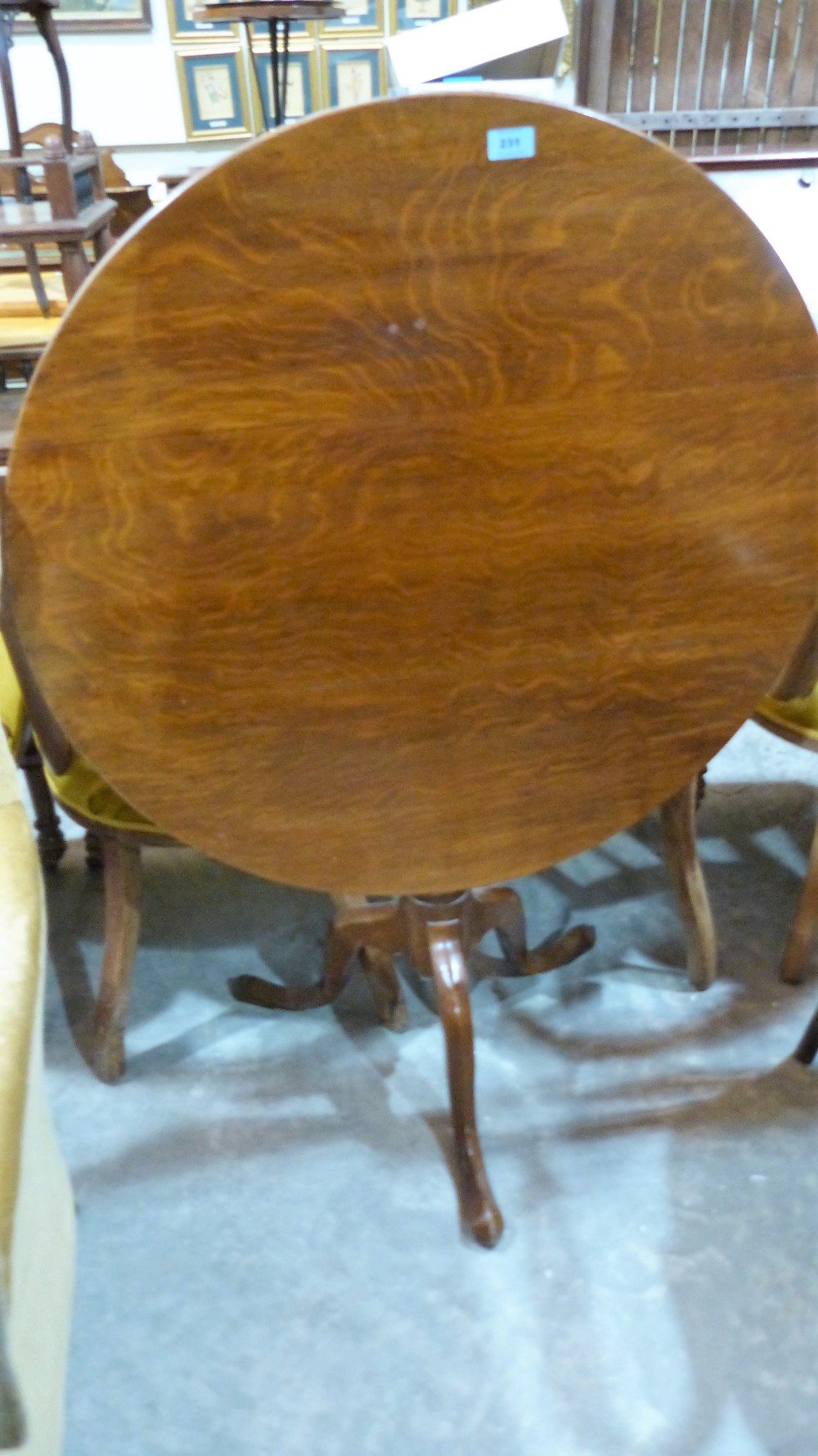 An oak snap-top tripod table. 32'' diameter