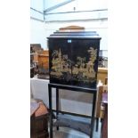 A 19th century oriental lacquered cabinet on stand, the fitted interior enclosed by a pair of