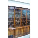 A mahogany breakfront library bookcase of recent manufacture, enclosed by four astragal glazed doors