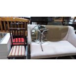 A pair of chairs, a glass topped table on tubular base and a 1950's wall mirror