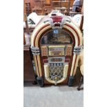 A juke box of recent manufacture with radio and playing CD's