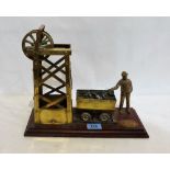 A brass model of a colliery lift engine with coal truck and miner. 13'' wide