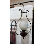 A hanging oil lamp with ruby glass fount and acid etched shade