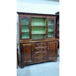 A Victorian stained pine dresser, the upper part with three shelves flanked by glazed cupboards,