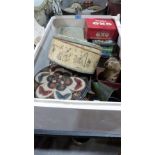 A box of old tins with two oil cans