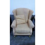 A good quality wing armchair upholstered in striped fabric