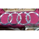 An Audi/Auto Union showroom concentric circles marque sign, marked for Armada b.v. plated plastic.