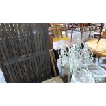 A hardwood garden table together with a painted metal set of four patio chairs and table