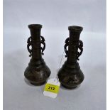 A pair of oriental bronze vases cast in relief with dragons and prunus. 7'' high