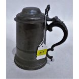 An 18th century pewter tankard with chair back thumb piece and double dome lid. 8'' high