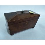 A George IV mahogany sarcophagus tea caddy on bun feet. 11'' wide