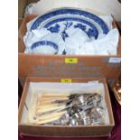 A box of Old Willow china and a quantity of cutlery