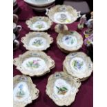 A 19th century English dessert service, finely painted with botanical subjects in reserves and