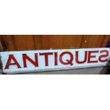 An 'Antiques' glass shop sign. 54'' wide