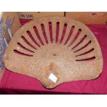 A cast iron tractor seat