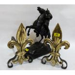 A pair of brass fleur-de-lys andirons and a speltar figure of a warrior on rearing horse