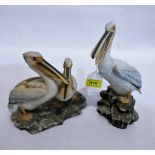 A pair of bisque figures of pelicans. Continental. 9¼'' and 7'' high