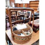 A wicker sewing basket and contents